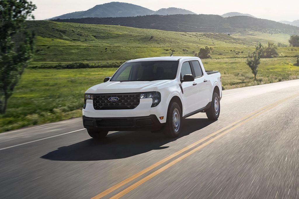 White ford maverick truck driving on a rural road