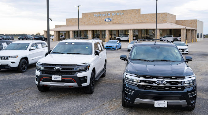 Ford SUVs parked in front of Platinum Ford North dealership.
