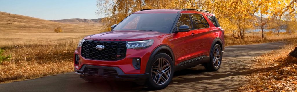 2026 Ford Explorer driving through an autumn landscape
