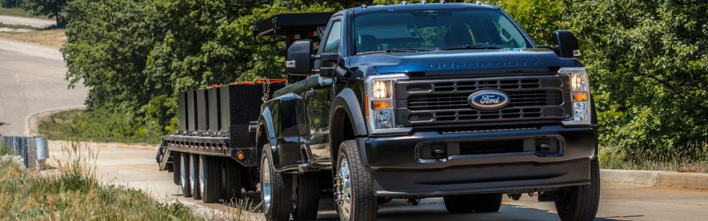 2026 Ford Super Duty truck towing a heavy load on the road