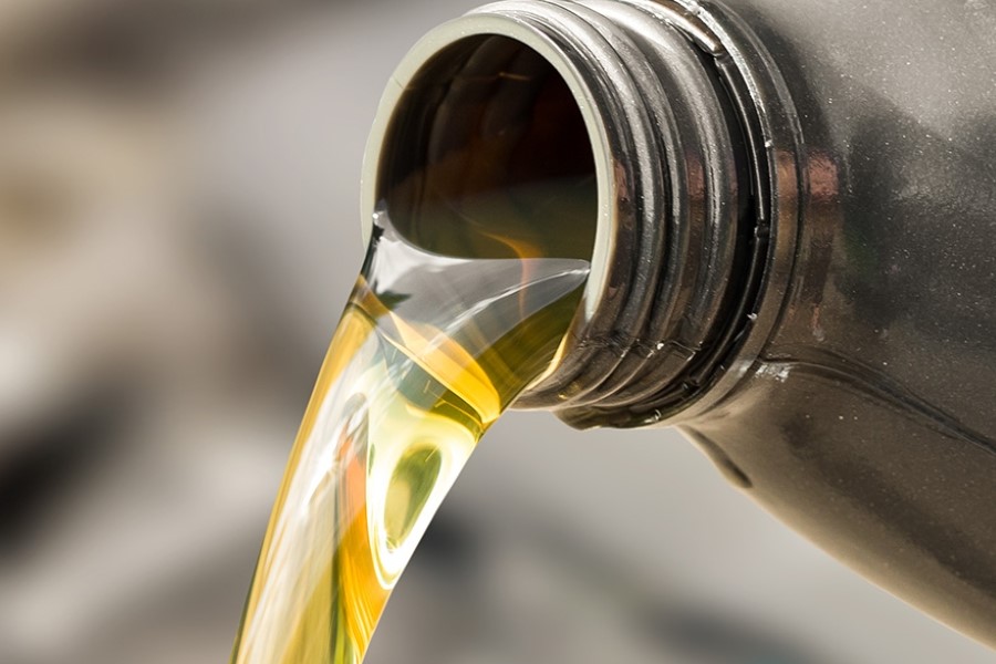 Fresh Brake oil pouring from a black plastic container.